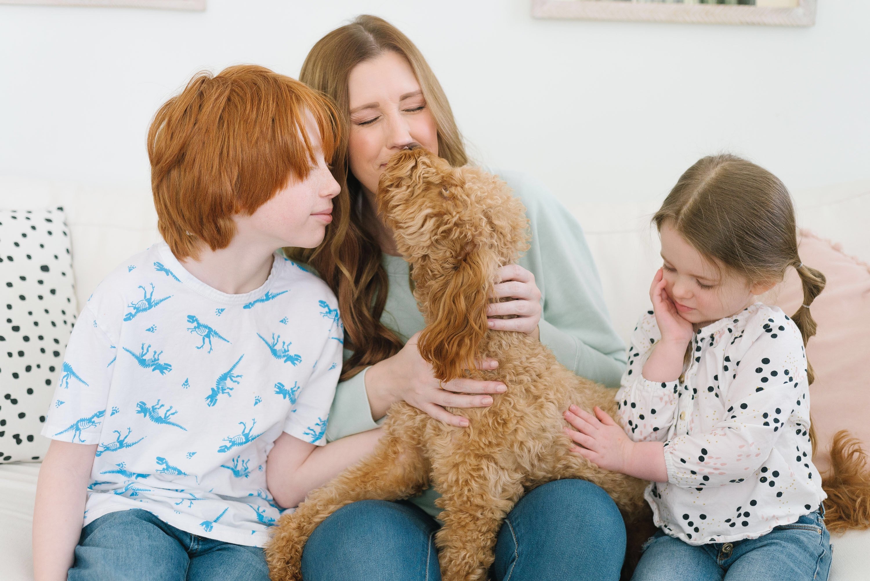 Mother and kids on the couch with family dog