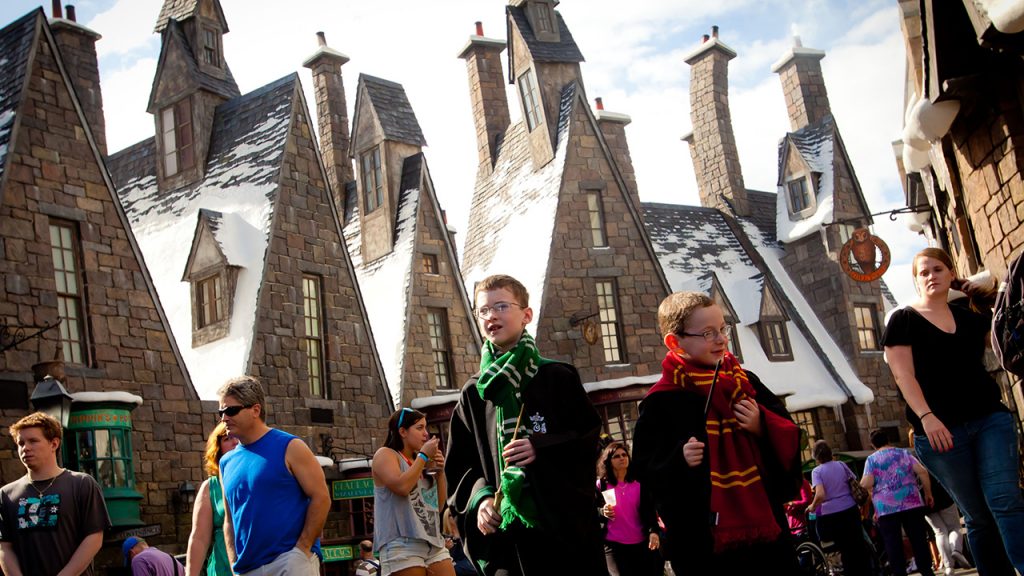 Guests walking through Hogsmeade village at Harry Potter World in Universal Studios Orlando