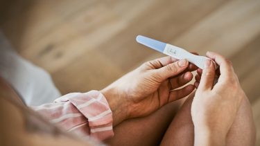 Women holding a negative pregnancy test