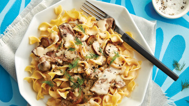 plate of beef stroganoff on a blue table cloth