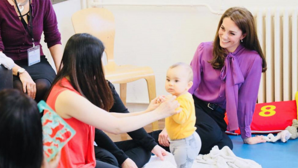 Kate Middleton sitting with a mom and her toddler