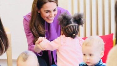 Kate Middleton playing with a little girl in a pink top
