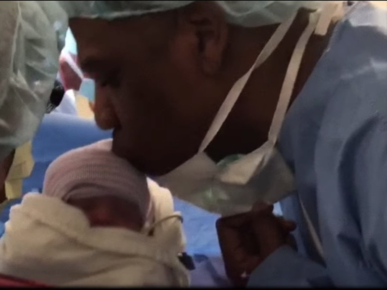 Jay-Z kissing a twin in the delivery room