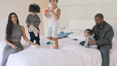 the kardashian-west family on a white bed