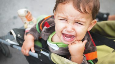 crying toddler in stroller