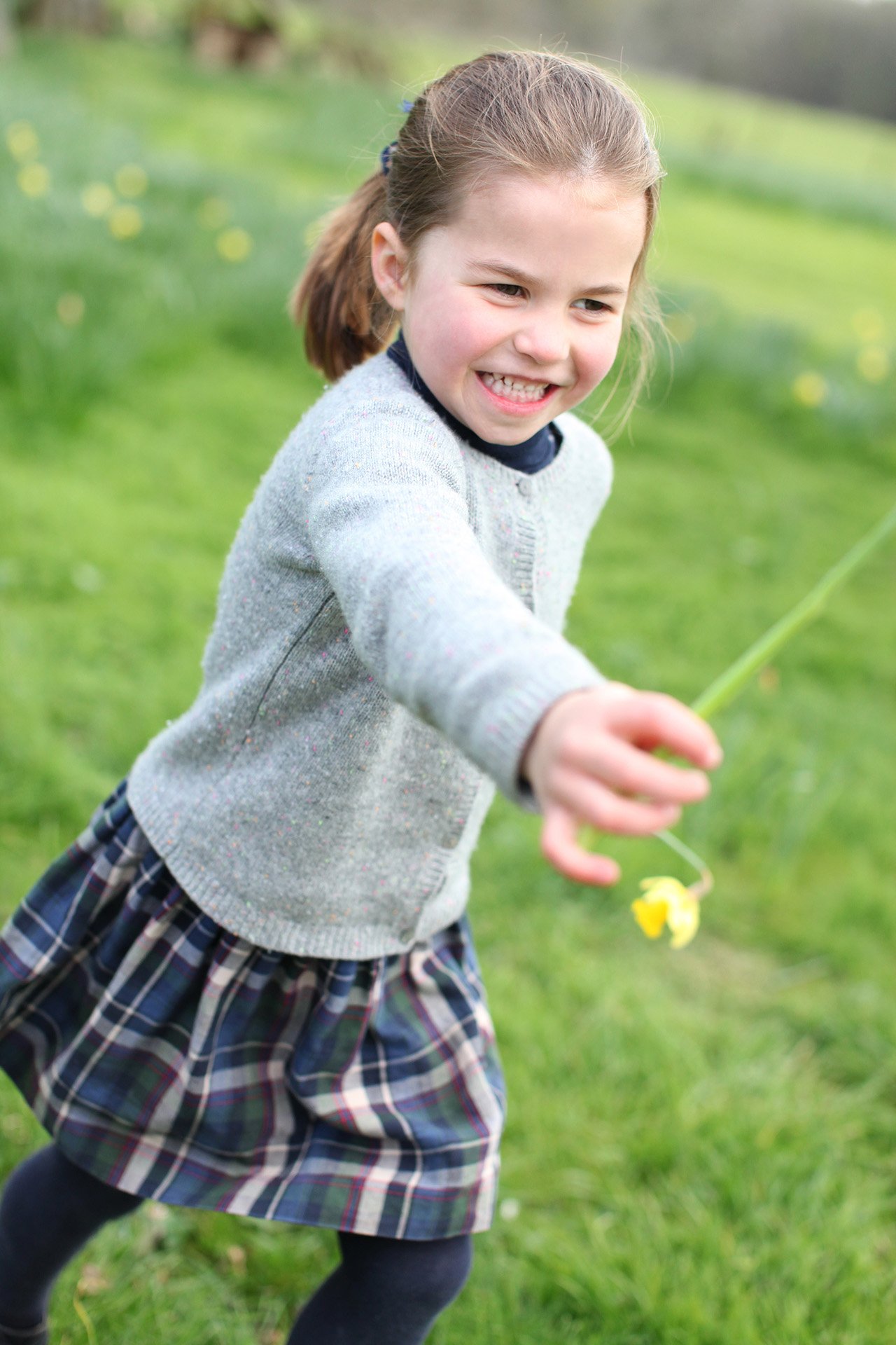 princess charlotte playing in a field