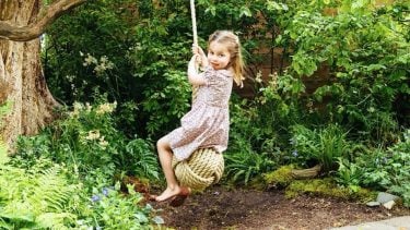 princess charlotte swinging on a rope swing