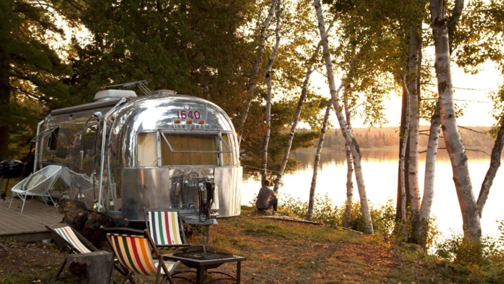 airstream on the side of a lake
