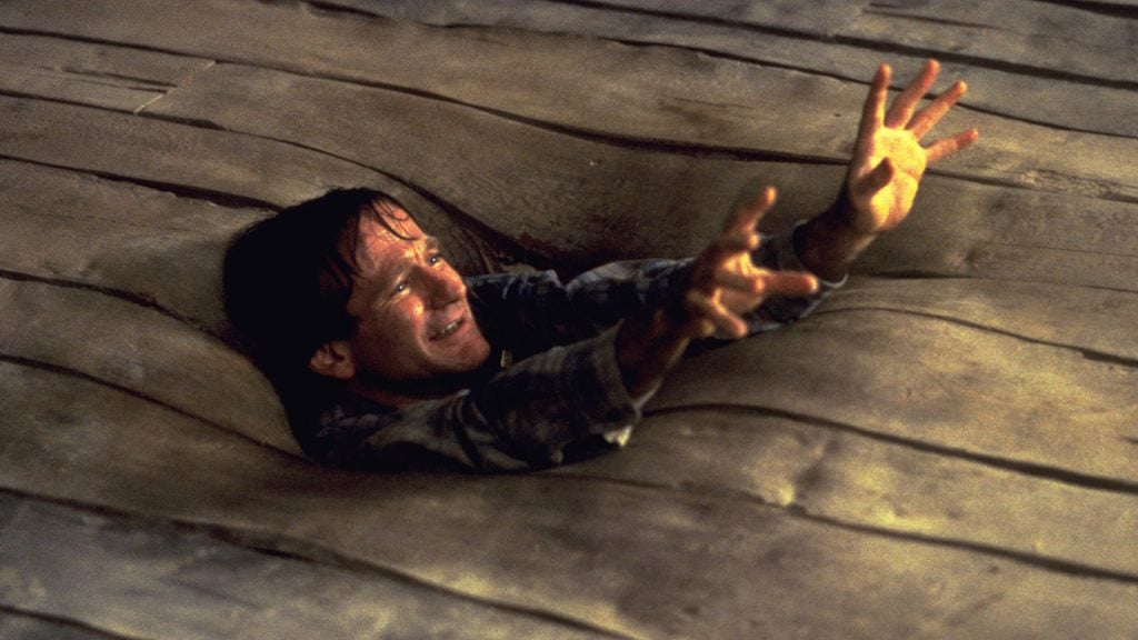 Promo image for Jumanji showing a dad falling into the floor