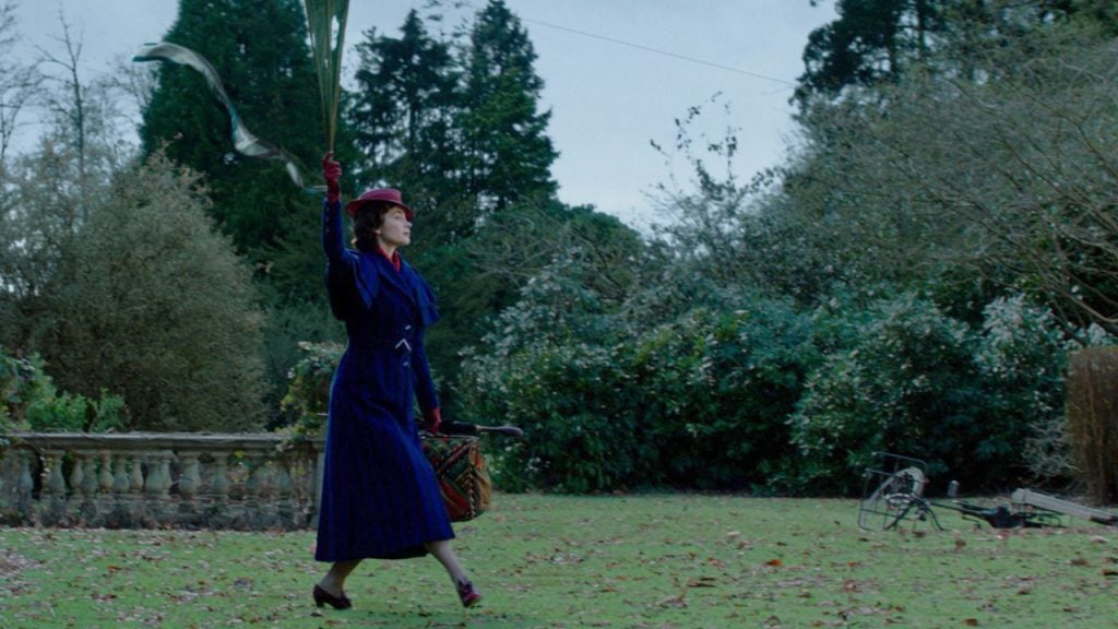 Promo image for Mary Poppins Returns showing Mary Poppins landing from a kite
