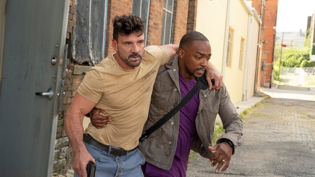 Promo image for Point Blank showing two men escaping through and alleyway