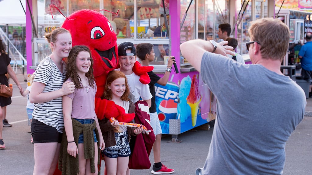 People take a photo with a lobster