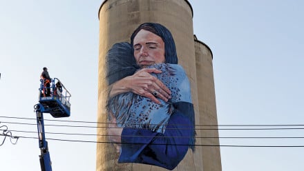 A photograph of the NZ PM embracing a Muslim woman reproduced by artist Loretta Lizzio as an 18-metre mural on a silo in Melbourne