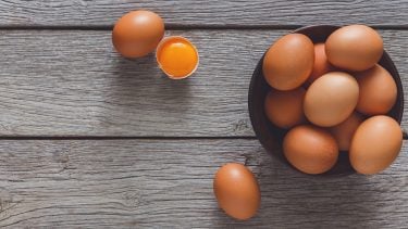 Egg allergy: Bowl of brown eggs on a wooden table