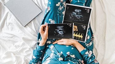 Pregnant mother looks at ultrasound pictures