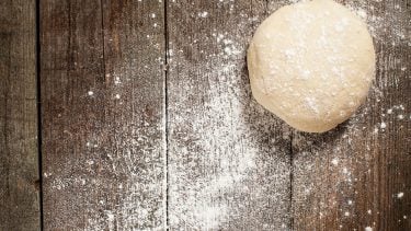 Wheat allergy: Ball of dough on a wooden board