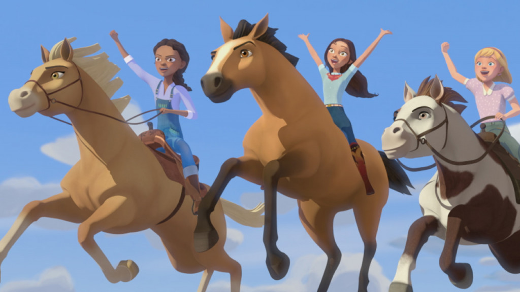 three girls riding horses that are jumping through the air