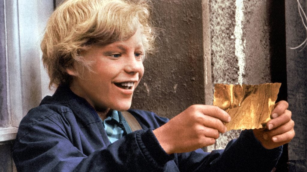 Kid holding a golden ticket