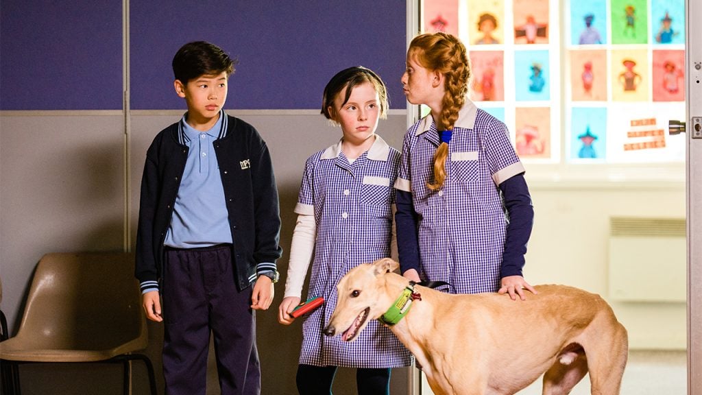 kids in a classroom with a greyhound