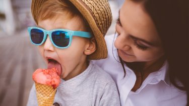 Lactose intolerance: Kid eating ice cream beside mom