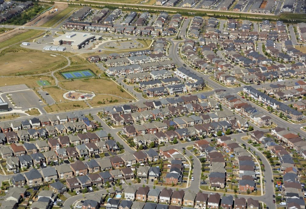 Aerial shot of a suburb with a school in the middle