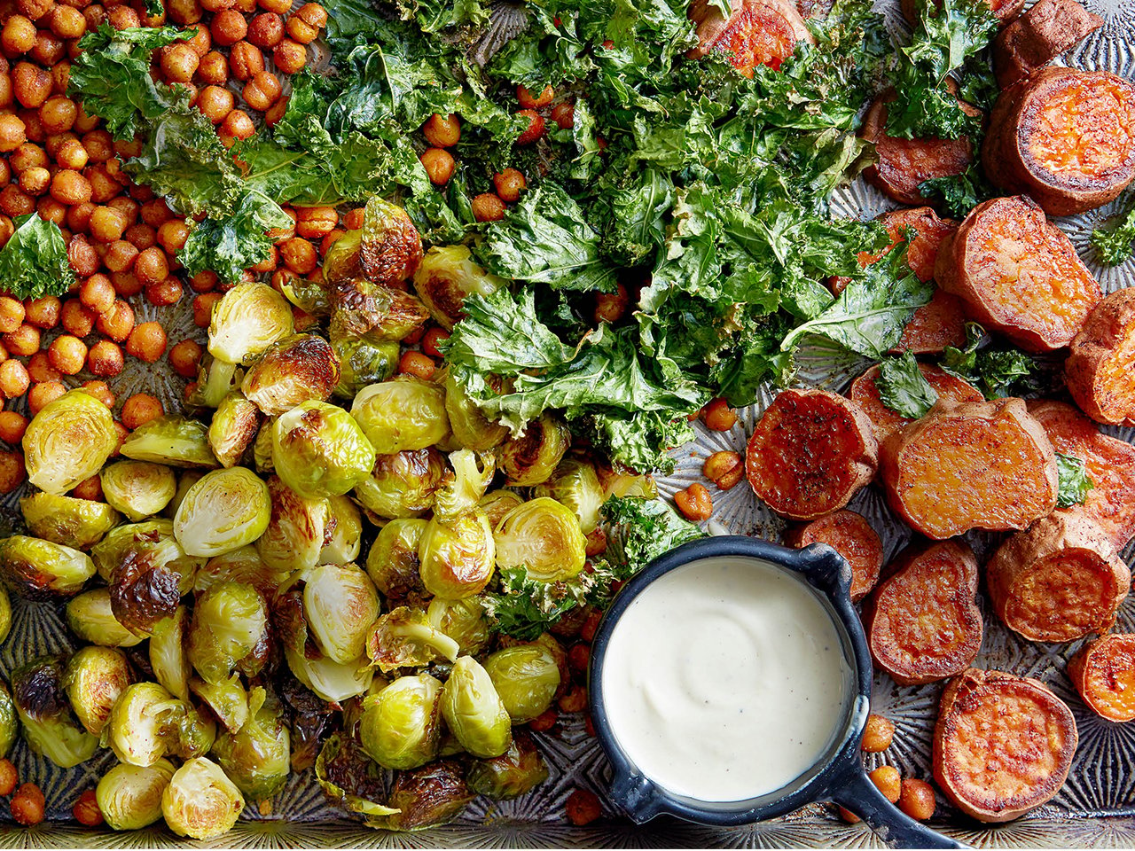 tray of roasted veggies with white sauce