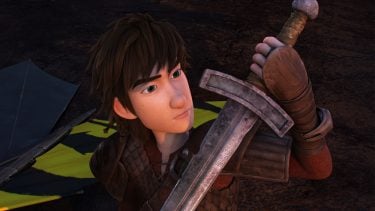 Hiccup from How to Traing Your Dragon holind a sword and looking at it
