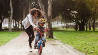 Mom teaches child to ride a bike