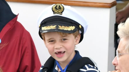 prince george smiling in a captain's hat missing middle teeth
