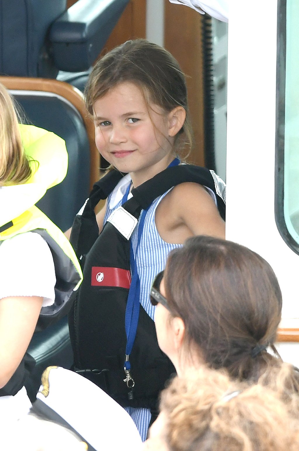 Princess Charlotte boating in a striped blue dress and life jacket