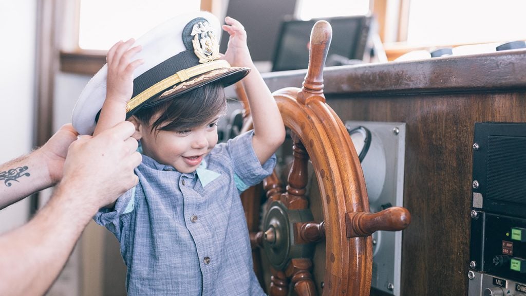 little boy wearing sailor hat