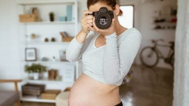 Third trimester: Pregnant woman taking a photo
