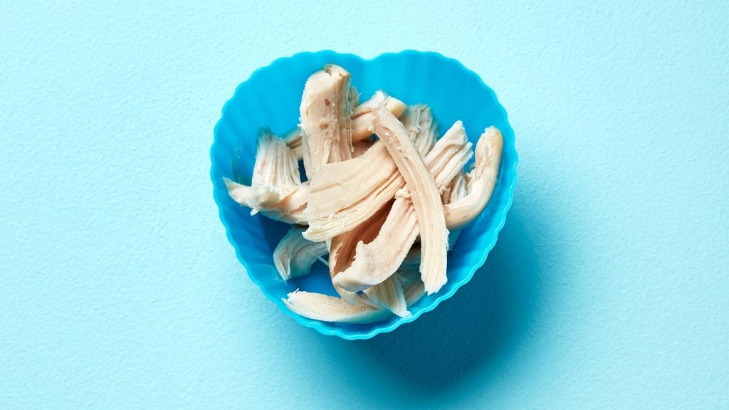 Shredded chicken in a blue heart-shaped cup