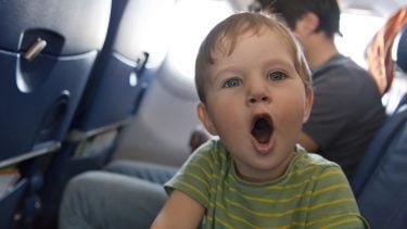young boy on airplane with his mouth wide open