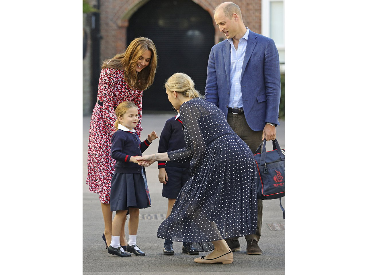 princess charlotte shaking her new school headmaster's hand