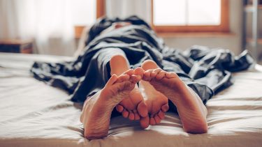 Pregnancy sex positions: A couple embracing each other in bed