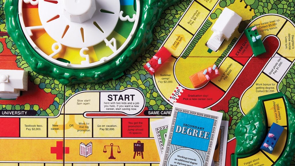 Overhead view of a Game of Life game board showing a card that says secondary degree