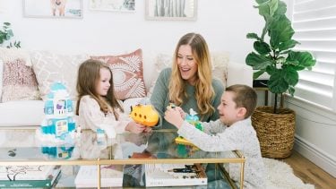 Renee M Leblanc playing with LEGO Duplo toy sets for young kids with her son and daughter