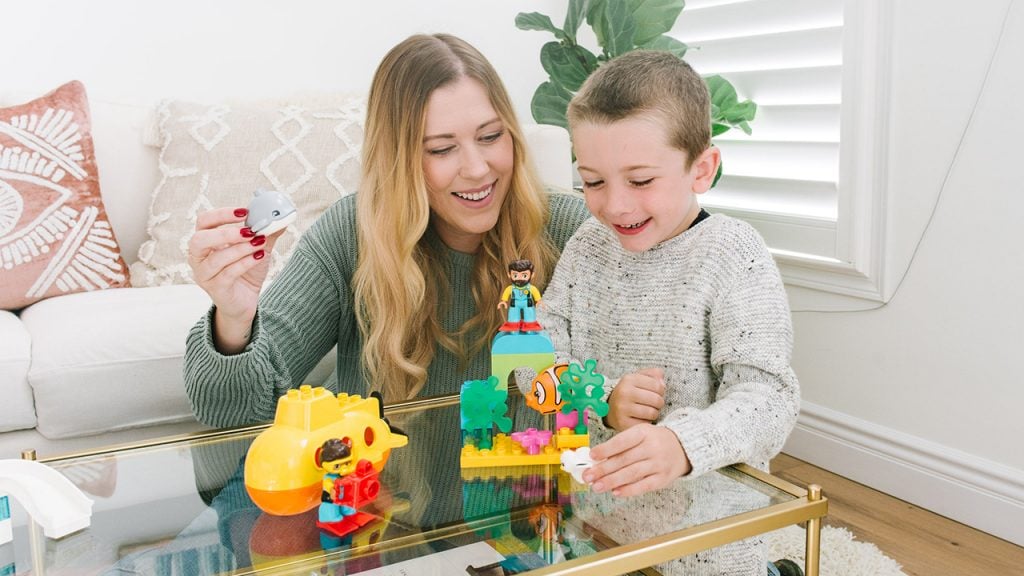 Renee M Leblanc playing with LEGO Duplo toy sets for young kids with her son