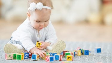 A baby plays with blocks.