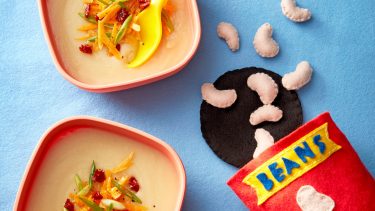 two bowls of creamy soup with felt decorations