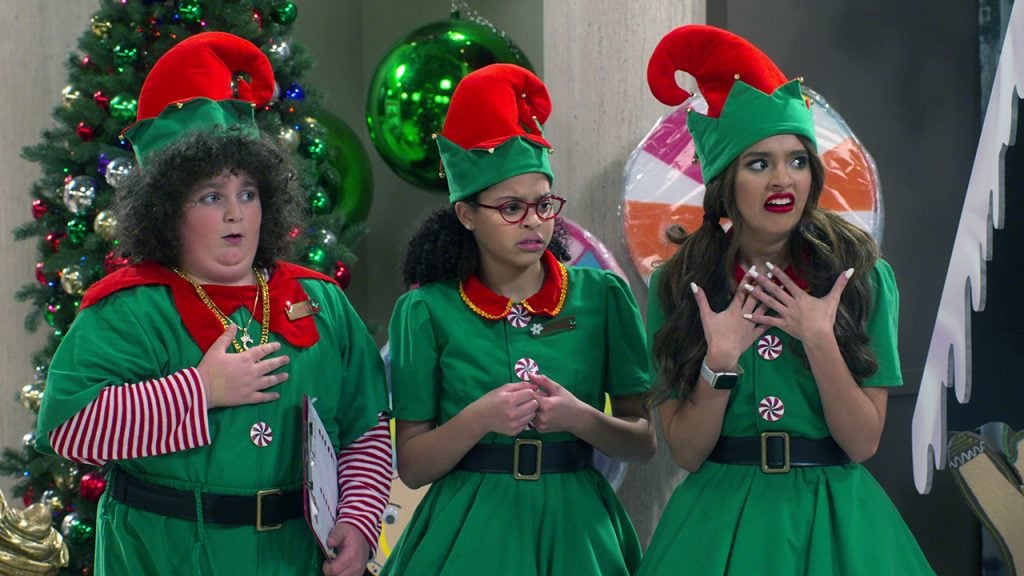 three adolescents in elf costumes looking shocked