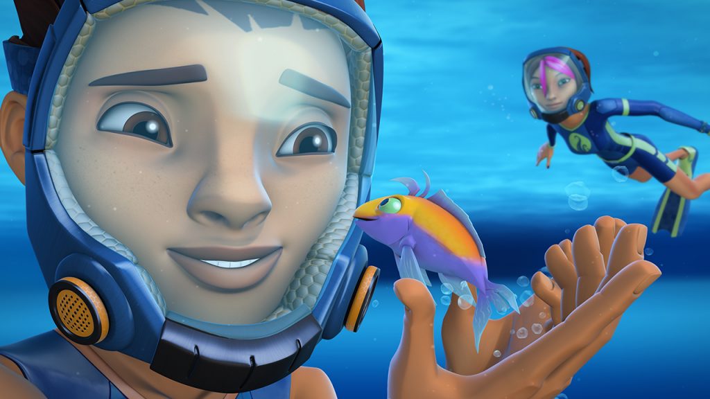 kid scuba diving and looking at a fish while a woman swims behind him