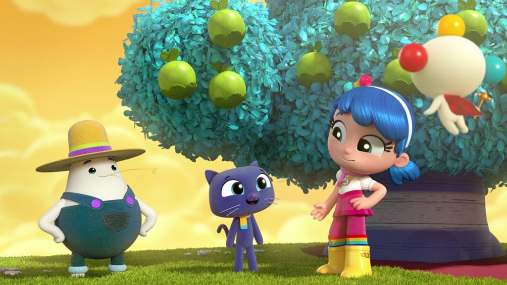 a girl standing under a tree with fruit talking to her friends