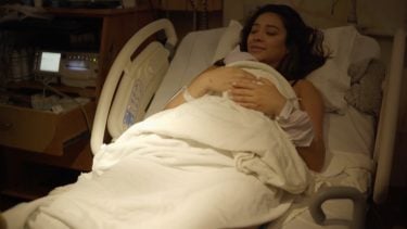 Shay cradles her newborn.