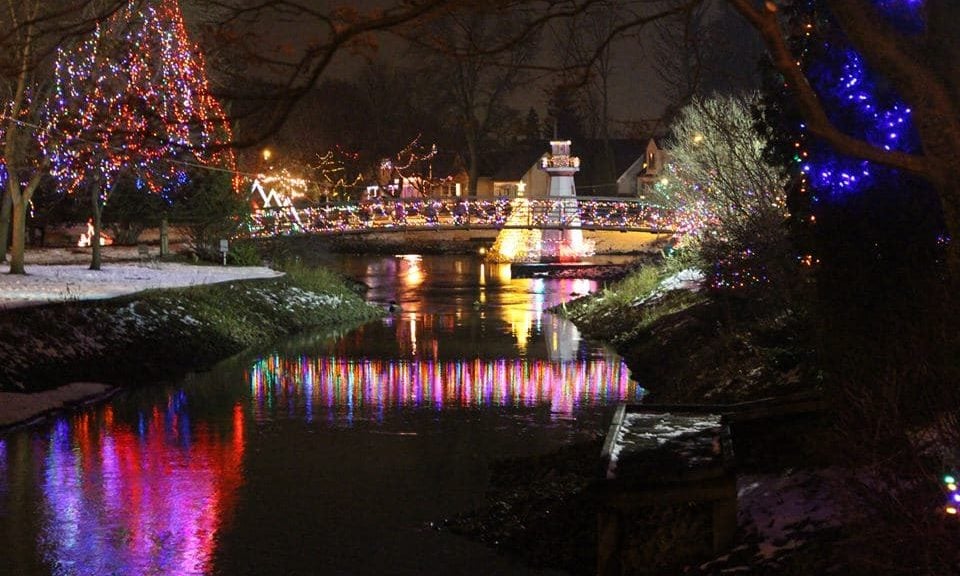 Lights on a bridge reflect into the water below