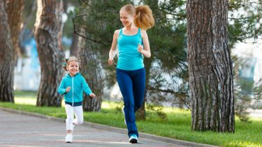 mother and daughter jogging in a park with a fitbit for kids