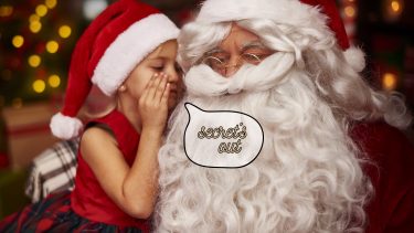 young girl whispering "secret's out" in Santa's ear how to tell kids about santa