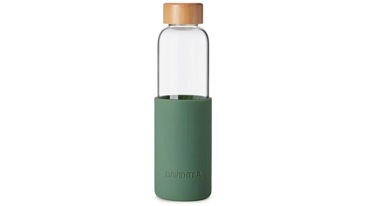 glass water bottle with olive-coloured silicone sleeve