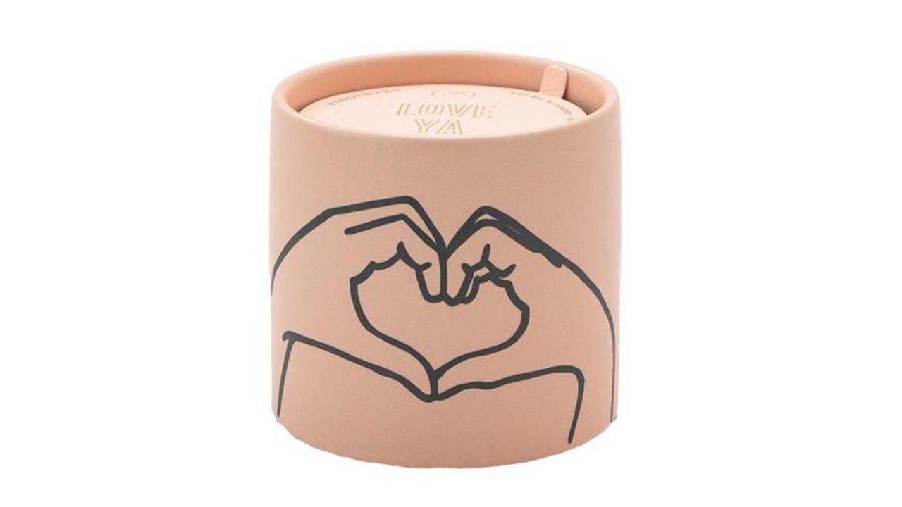 terracotta candle with illustration of hands making heart shape